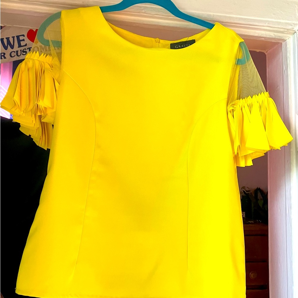 Medium yellow blouse. Never worn. Fun flair mesh sleeves.